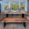 Spacious community kitchen with rustic style wood table and large windows with a view.